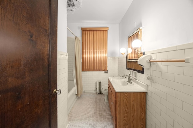 full bathroom with radiator, vanity, tile patterned floors, toilet, and tile walls