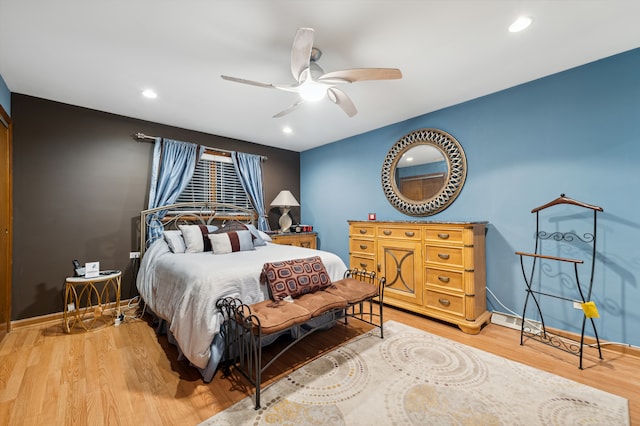 bedroom featuring hardwood / wood-style floors and ceiling fan