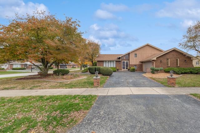 view of front facade with a garage and a front yard