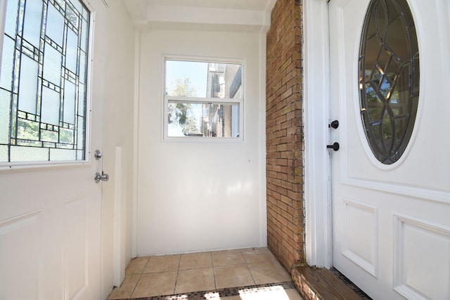 doorway to outside with a wealth of natural light and light tile patterned flooring