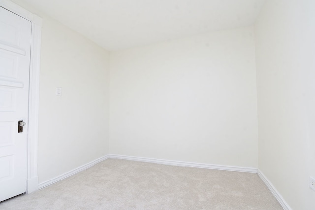 unfurnished room with light carpet