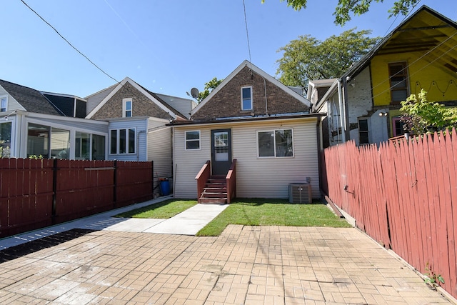 rear view of property featuring a patio and central AC unit