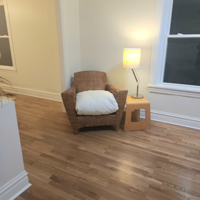 living area with hardwood / wood-style flooring