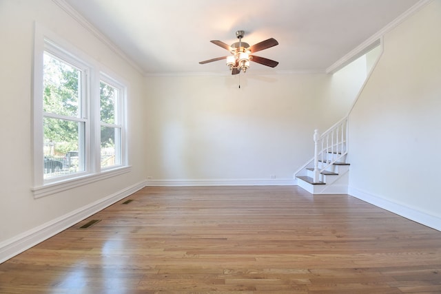 interior space featuring wood-type flooring, ceiling fan, and ornamental molding