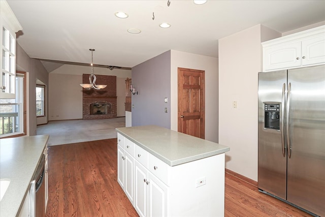 unfurnished living room featuring light carpet, high vaulted ceiling, a brick fireplace, and ceiling fan