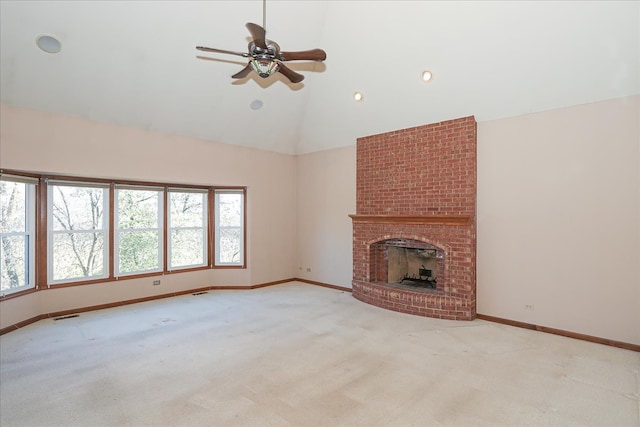 unfurnished living room with ceiling fan with notable chandelier, high vaulted ceiling, and dark hardwood / wood-style floors