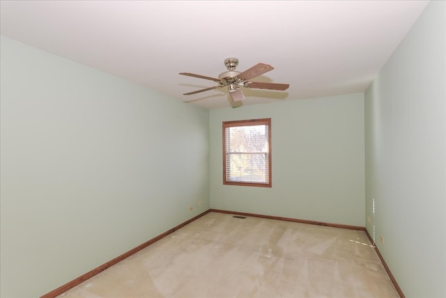 spare room featuring ceiling fan and light colored carpet