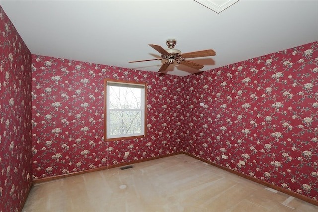 basement featuring a paneled ceiling and light carpet