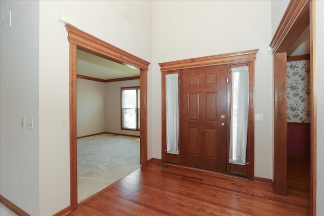 spare room with light colored carpet and crown molding