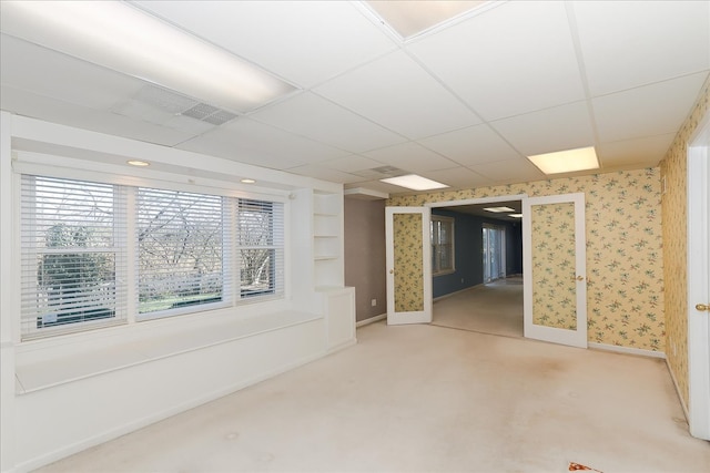 basement with a drop ceiling and carpet floors