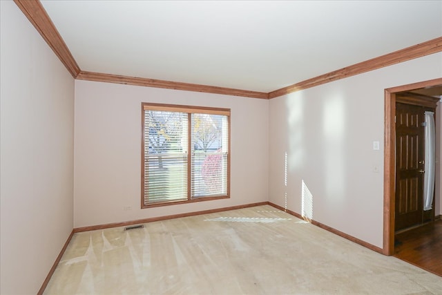 spare room with wood-type flooring, ornamental molding, and an inviting chandelier