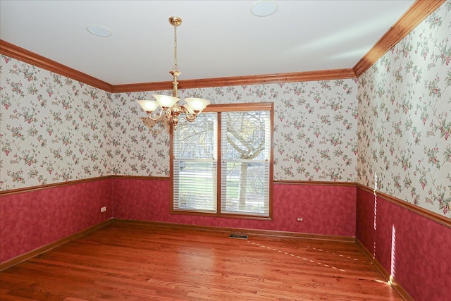 kitchen with appliances with stainless steel finishes, sink, wood-type flooring, white cabinets, and a center island