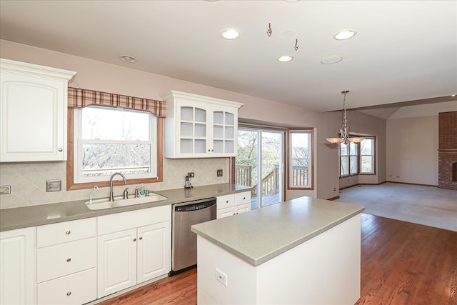 kitchen featuring stainless steel appliances, a kitchen island, dark hardwood / wood-style floors, and sink