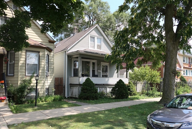 bungalow-style house featuring a front lawn