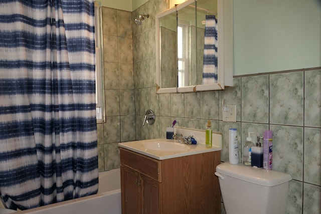 full bathroom featuring tile walls, vanity, shower / tub combo with curtain, and toilet