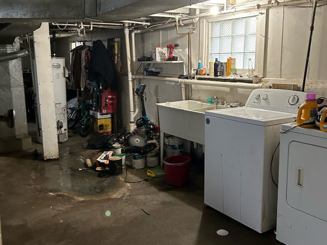 basement featuring water heater, sink, and washing machine and clothes dryer