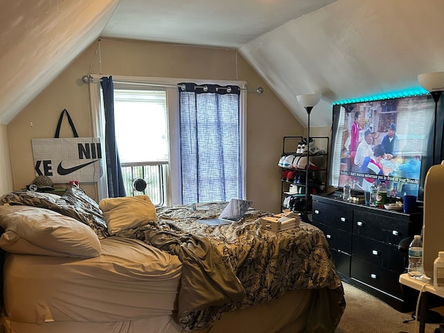 bedroom featuring vaulted ceiling and carpet floors