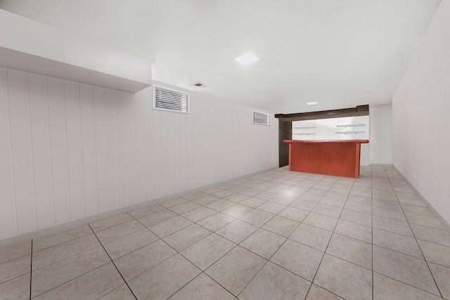 tiled spare room with wooden walls