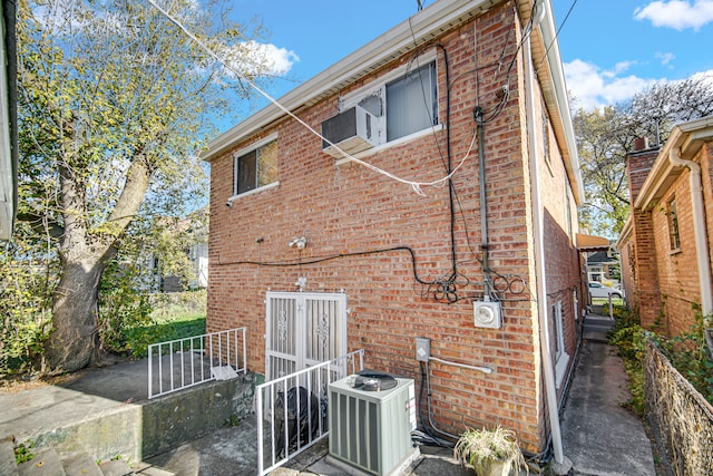 rear view of property with central AC