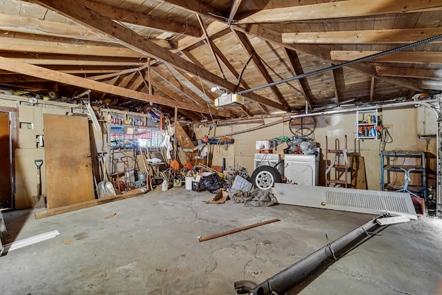 garage with a garage door opener and washing machine and clothes dryer