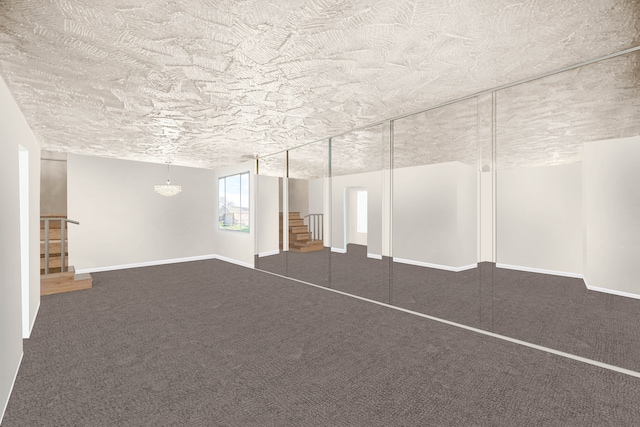 basement featuring a textured ceiling and dark colored carpet