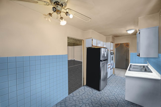 8916 S Eggleston Ave, Chicago, IL 60620 - kitchen with freestanding refrigerator, a sink, oven, a ceiling fan, and light tile patterned floors