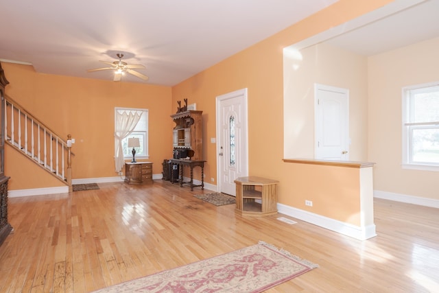 foyer with light hardwood / wood-style flooring and ceiling fan