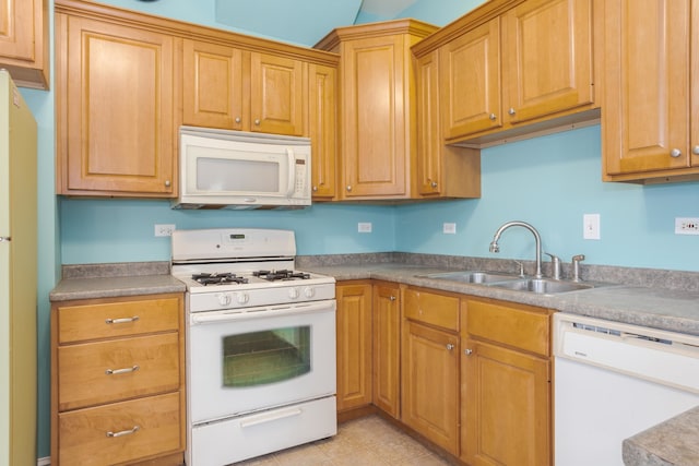 kitchen featuring light tile patterned flooring, white appliances, and sink