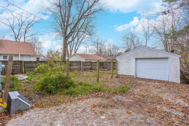 view of yard with a garage and an outdoor structure