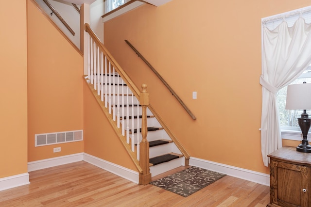 stairway with hardwood / wood-style flooring