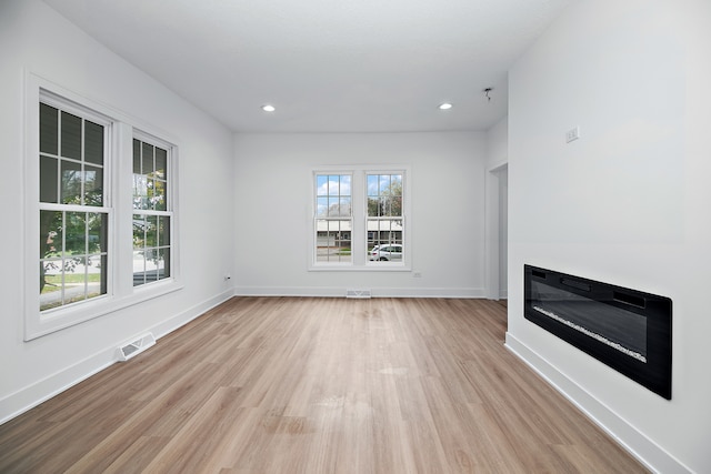 unfurnished living room with light hardwood / wood-style flooring