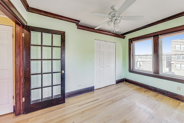 unfurnished bedroom featuring ornamental molding, light hardwood / wood-style flooring, ceiling fan, and a closet