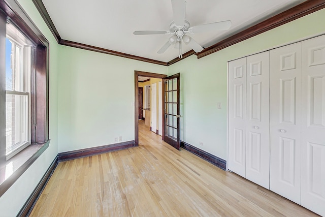 unfurnished bedroom with ceiling fan, multiple windows, a closet, and light hardwood / wood-style flooring