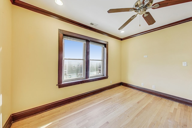 empty room with ornamental molding, light hardwood / wood-style flooring, and ceiling fan