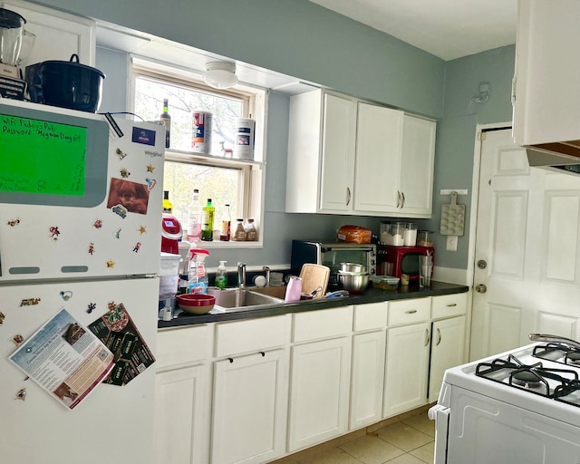 kitchen with white cabinets, white appliances, and light tile patterned floors