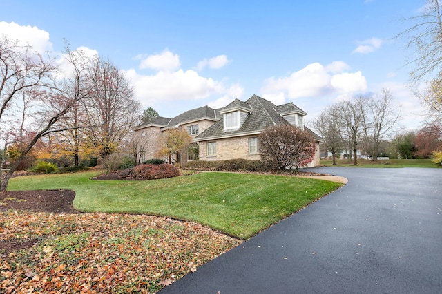 view of property exterior featuring a lawn