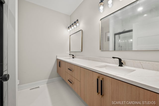 bathroom with tile patterned flooring and vanity