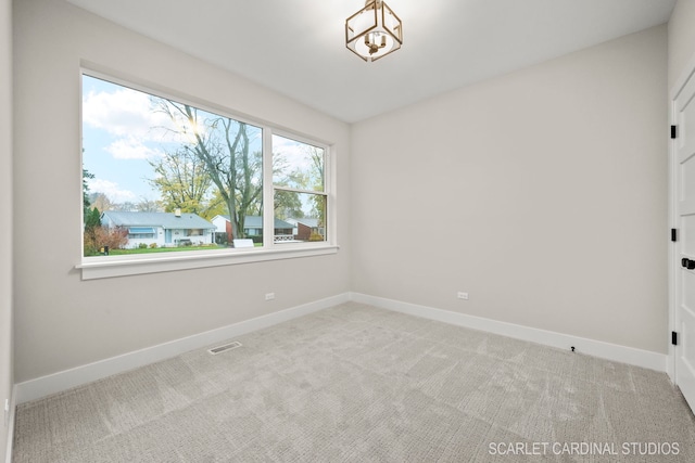 spare room with carpet flooring and plenty of natural light