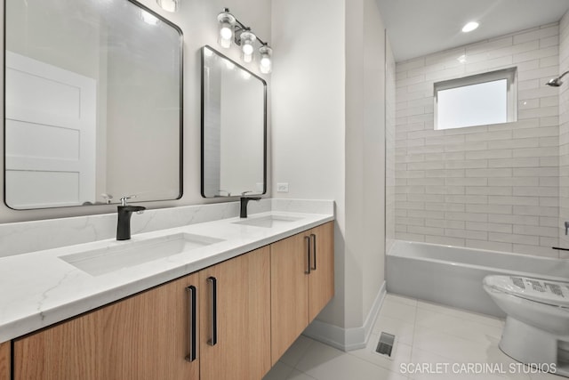 full bathroom featuring tile patterned flooring, vanity, toilet, and tiled shower / bath