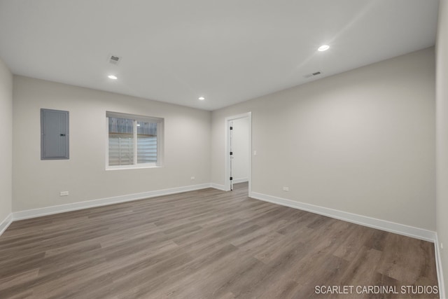 spare room featuring light hardwood / wood-style floors and electric panel