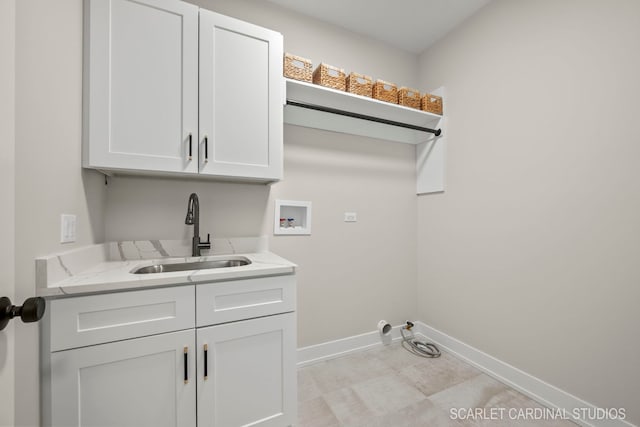 clothes washing area featuring cabinets, sink, washer hookup, and gas dryer hookup