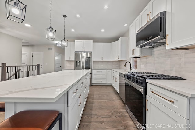 kitchen with white cabinetry, a center island, dark wood-type flooring, stainless steel appliances, and decorative light fixtures