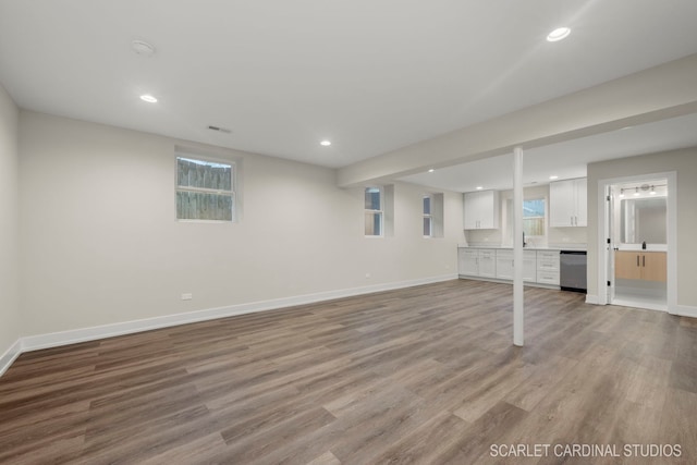 unfurnished living room with light hardwood / wood-style flooring and sink