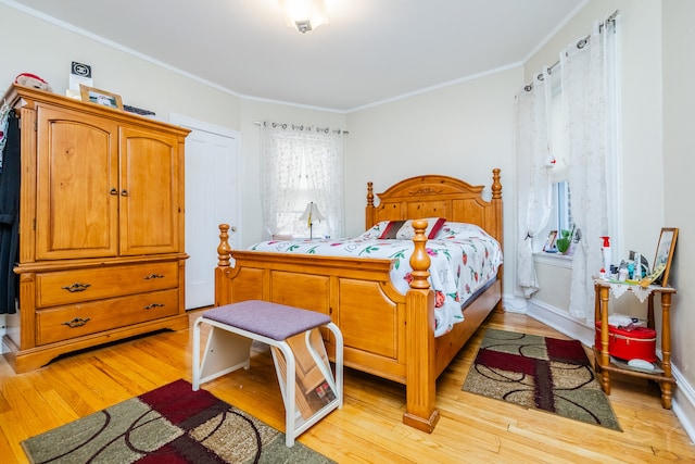 bedroom with ornamental molding and light wood-type flooring