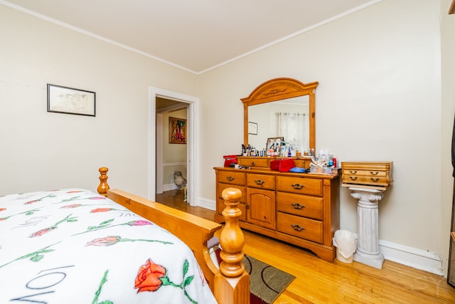 bedroom featuring light hardwood / wood-style floors and crown molding