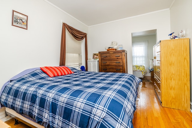 bedroom with crown molding and hardwood / wood-style floors