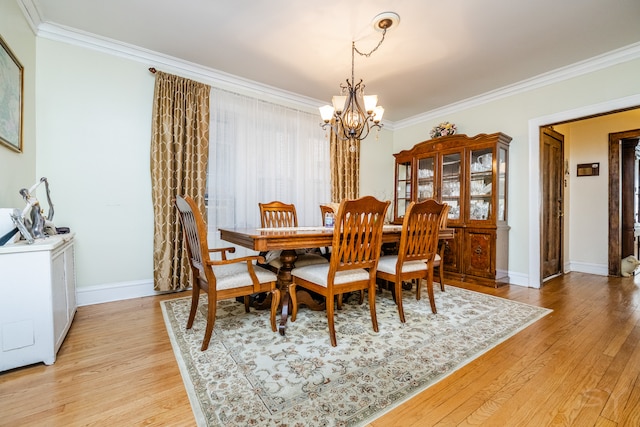 dining area featuring an inviting chandelier, light hardwood / wood-style flooring, and crown molding