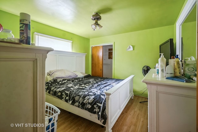 bedroom with a closet and light hardwood / wood-style flooring