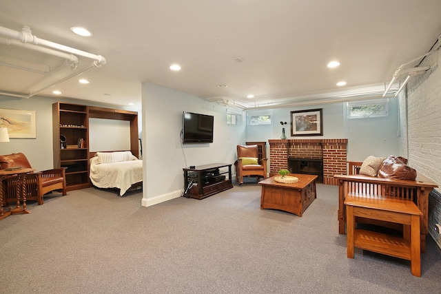 carpeted bedroom with brick wall, a fireplace, and recessed lighting