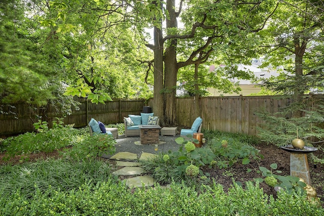 view of yard featuring a fenced backyard, outdoor lounge area, and a patio